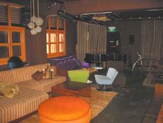 Lounge area with grand piano in the background.