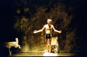 Paddy Chew showing his emaciated frame onstage.