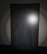 The first "Strange looking door" the player encounters, note the blue liquid splattered over it. (Credit to MisterRedirect)