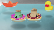 Sage and Ginger in separate donut floaties