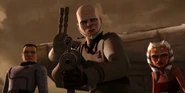 Kilian pointing Bossk's blaster rifle at him