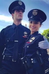 Paige in her uniform (with Det. Nolan) from behind-the-scenes material for “”.
