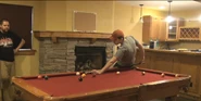 Kootra playing pool in the basement.