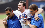 Trainers Ray Ramirez and Mike Herbst wearing Mets shirt with the Nike logo on the top right corner and the Mets Script on the left corner.