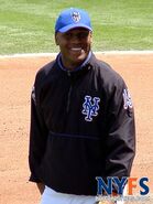 The number jacket which is used during BP. The number of the player is one the left sleeve in blue and orange. The Mets dark patch is on the right and the NY script is to the left on the front. On the middle section is a blue line.