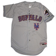 The road uniform is grey with Buffalo inscribed on it with the NY Mets script underneath it on the left. The Bisons patch is on the left sleeve. The name and number on the back is in white.