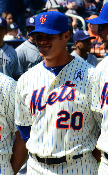 New York Mets' Anthony Recker runs through a gauntlet of towels in