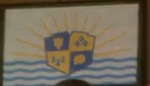 One of two Auradon flags displayed while Lumiere measures Prince Ben.
