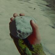 Throwable rock in hand
