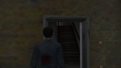 The front door entrance to the Yardie Drug Factory with a staircase leading to the first floor.