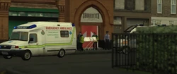 A body is removed from the entrance of Shoreditch Boys following the massacre.
