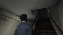 The first floor stairwell leading to the second floor in the Yardie Drug Factory.