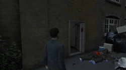 The back entrance to the Yardie Drug Factory with the door open.