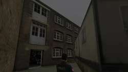 Behind the Used Car Yard building revealing an open entrance to the Yardie Drug Factory.