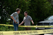 Jim talks to "Wayne" at the newly discovered crime scene.