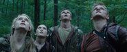The Careers observe Katniss from the ground