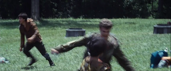 Marvel pushes down the District 8 male and raises his kukri.