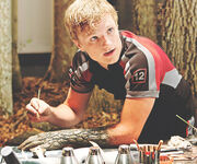 Peeta Mellark camouflaging his arm during training.