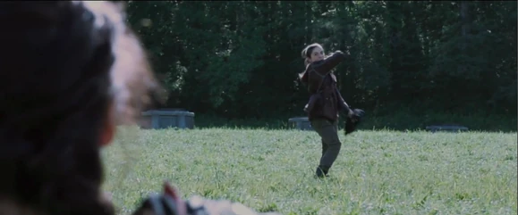 Clove prepares to throw a knife at Katniss next.