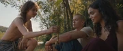 Clerk Carmine bringing katniss to Lucy Gray.