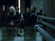 Districts 4, 5 and 6 observe Beetee as he leaves.