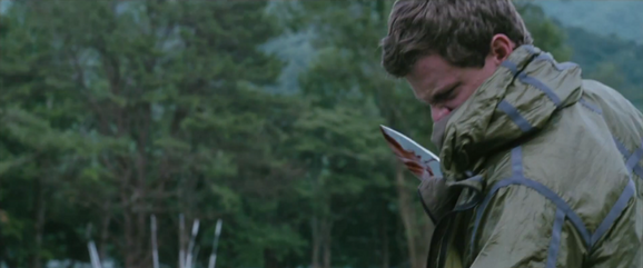 Marvel slashes the District 8 male with the kukri, coating the blade in blood