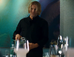 Haymitch sirviendose una copa