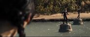 Katniss observes Brutus and the District 5 male on their pedestals.