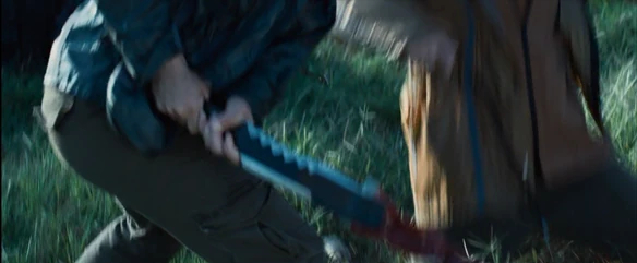 District 4 female slits the District 3 female's legs.