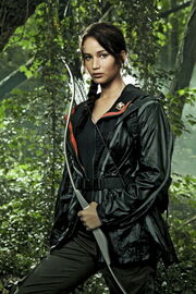 Katniss with her bow and arrows in the 74th Hunger Games arena.