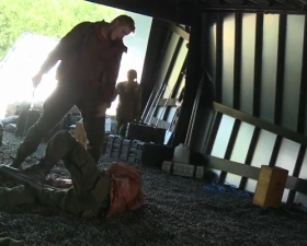 Cato has just slammed the District 6 male to the ground and prepares to stab him to death with a serrated sword while Glimmer watches.