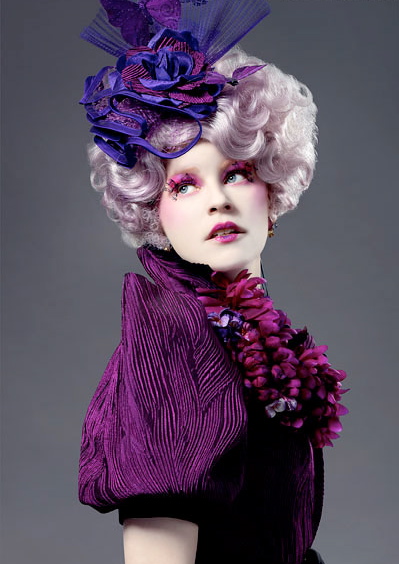 Can you provide a detailed description of Effie Trinket\'s role in the Hunger Games series?