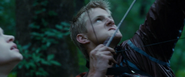 Cato attempts to shoot Katniss with a bow