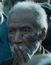 The elderly man about to salute Katniss.