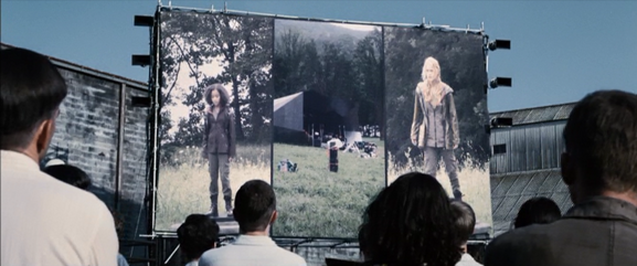 Rue and Glimmer appear on screen in District 12.