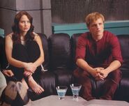 Katniss and Peeta watching the television.