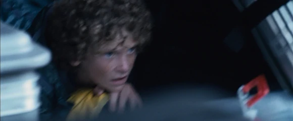 The District 4 male watches the fighting of the other tributes in fear.