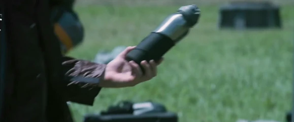 Cato picks up a water canteen next to the District 3 female's corpse.