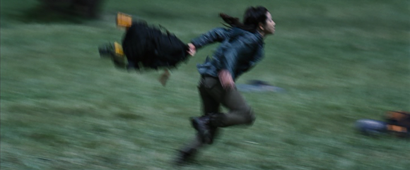 After failing to kill Cato, the District 4 female runs away with a backpack.