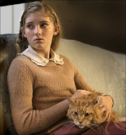 Buttercup sitting in Prim's lap in The Hunger Games: Catching Fire