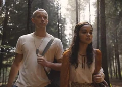 Snow and Lucy Gray escaping in the forest