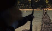 Katniss shooting an arrow towards Enobaria