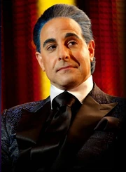 Caesar Flickerman in his blue suit in The Hunger Games film.