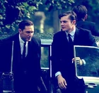 Tom Hardy portraying Reggie Kray, and Chris Mason portraying Ronnie Hart in Legend, 2015.