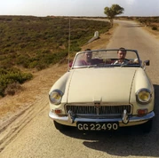 Ron Kray being driven by Ian Barrie during a holiday.