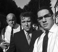 Adam Fogerty (left) portraying Big Pat in the 2015 film, Legend.
