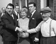 Found not guilty of demanding money with menaces, Violet (centre) with the twins either side stand with her father Jimmy Lee (right) outside 178 Vallance Road, 5th April 1965.