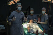 Ellie surrounded by the Firefly surgical team.