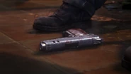 Riley's pistol on the ground.