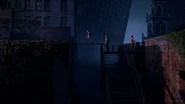 Ellie, Joel, and Tess crossing a roof in Boston.